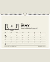 British Weather Club 2027 wall calendar, May page with wellies and a puddle