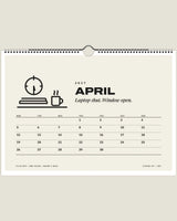 Clocking Off 2027 wall calendar, April page with closed laptop and mug