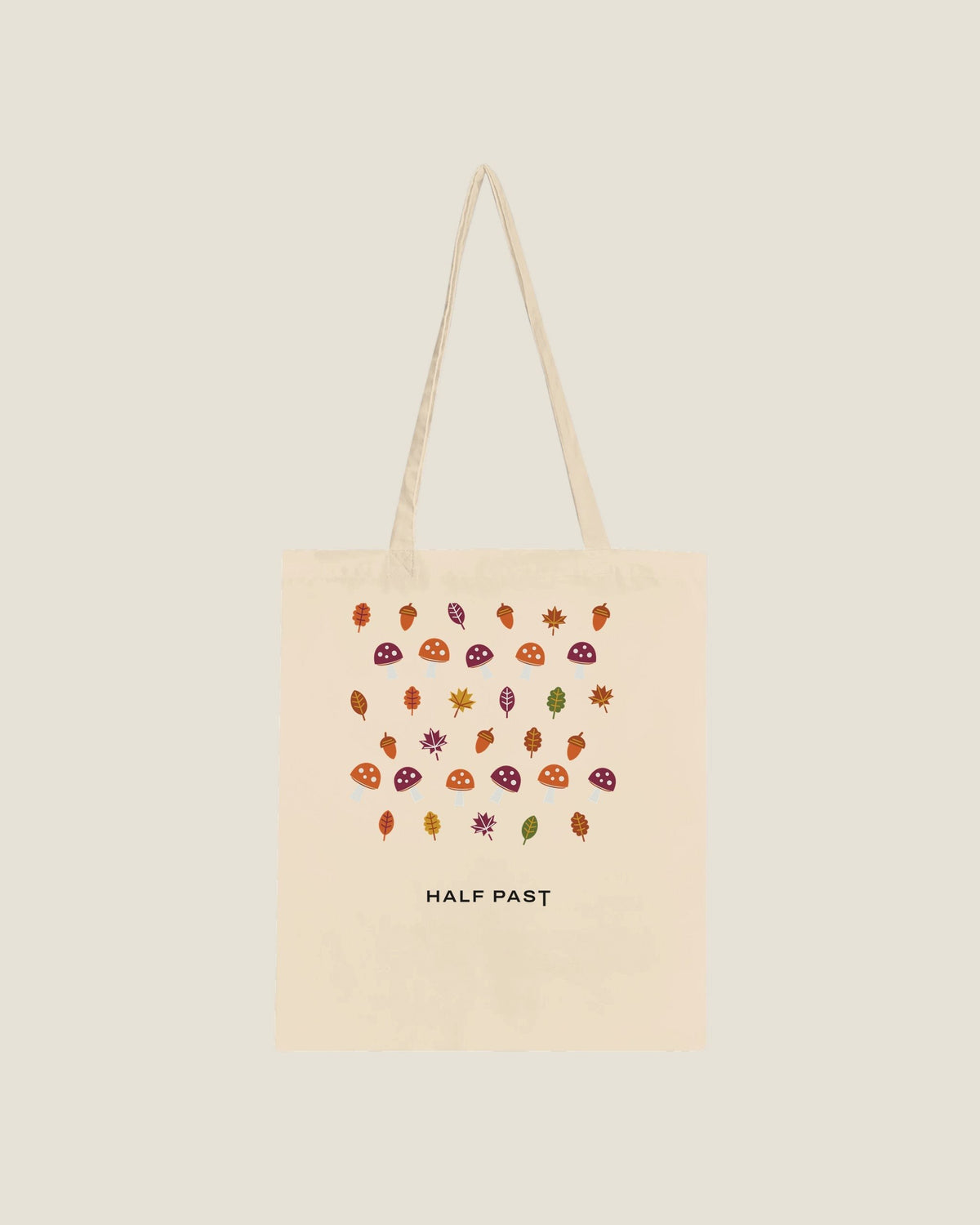 Mushroom tote in Natural: toadstools, acorns and autumn leaves with the Half Past wordmark