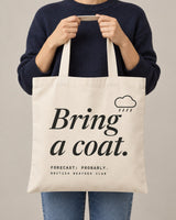 Bring a Coat tote in Natural, held by a model