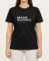 Made Slowly tee in Black, worn by a model, studio photo