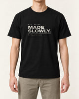 Made Slowly tee in Black, worn by a model, studio photo