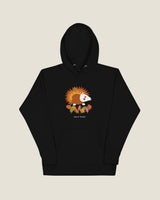 Hedgehog hoodie in Black: a hedgehog in autumn leaves, Half Past wordmark below